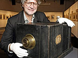 Peter Coeln, owner of an art and photo gallery, poses with a Susse Freres 'Le Daguerreotype' camera from 1839 in Vienna in March 2007. The camera, ancestor of modern photography, was sold at auction in Vienna Saturday for nearly 600,000 euros making it the world's oldest and most expensive commercial photographic apparatus.(AFP/File/Dieter Nagal)