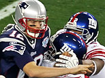 Quarterback Tom Brady #12 of the New England Patriots is hit as he throws by defensive tackle Barry Cofield #96 and Osi Umenyiora #72 of the New York Giants in the first half during Super Bowl XLII on February 3, 2008 at the University of Phoenix Stadium in Glendale, Arizona. (Photo by Jim McIsaac/Getty Images)